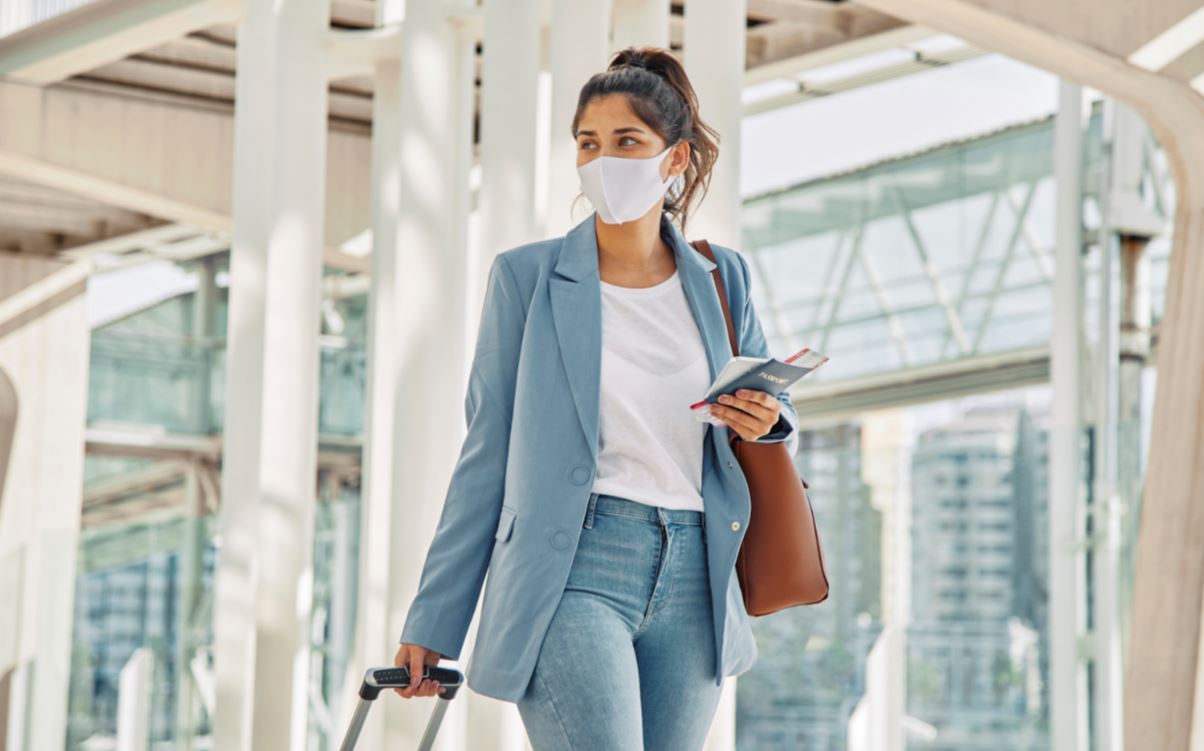 Woman with Luggage and Medical Mask 