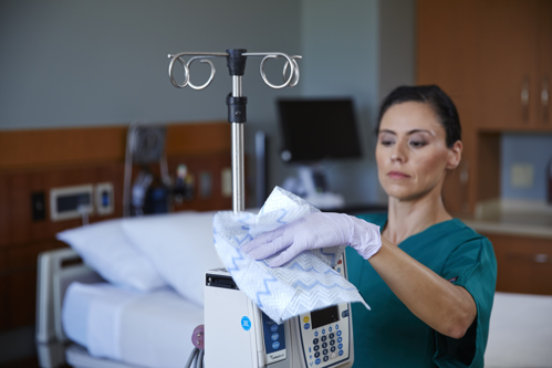 Nurse cleaning hospital machine with Disposable Microfibre Cloth