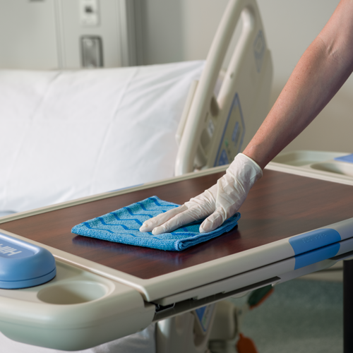 A person cleaning with HYGEN Microfibre cloth