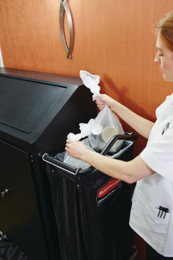 Lady putting rubbish into housekeeping cart